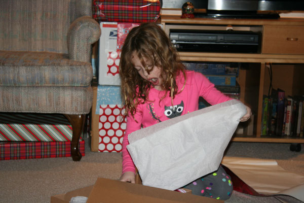 Irene unwrapping her Santa gift