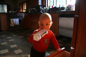 Sam the Anti-Preemie plays with a bottle