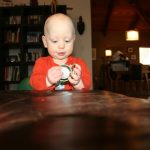 Sam the Anti-Preemie plays with a plate