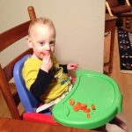 Sam the Anti-Preemie Eats a Persimmon