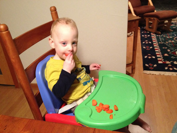 Sam the Anti-Preemie Eats a Persimmon